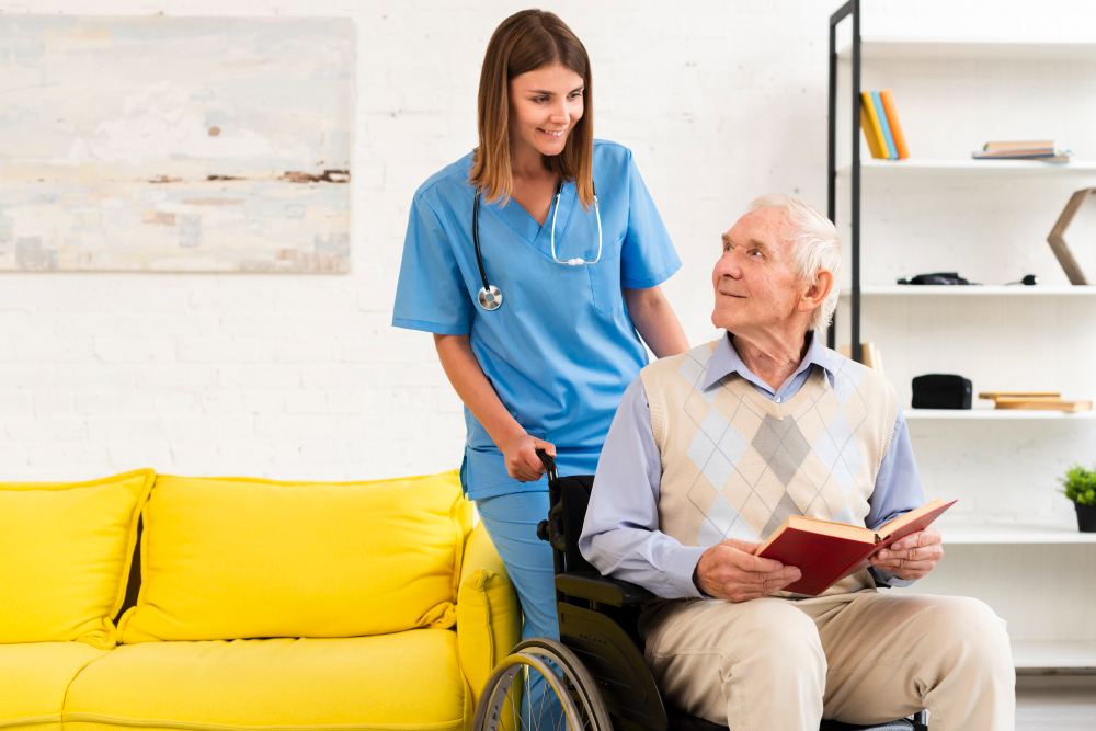 A nurse in scrubs talking with an older man at home