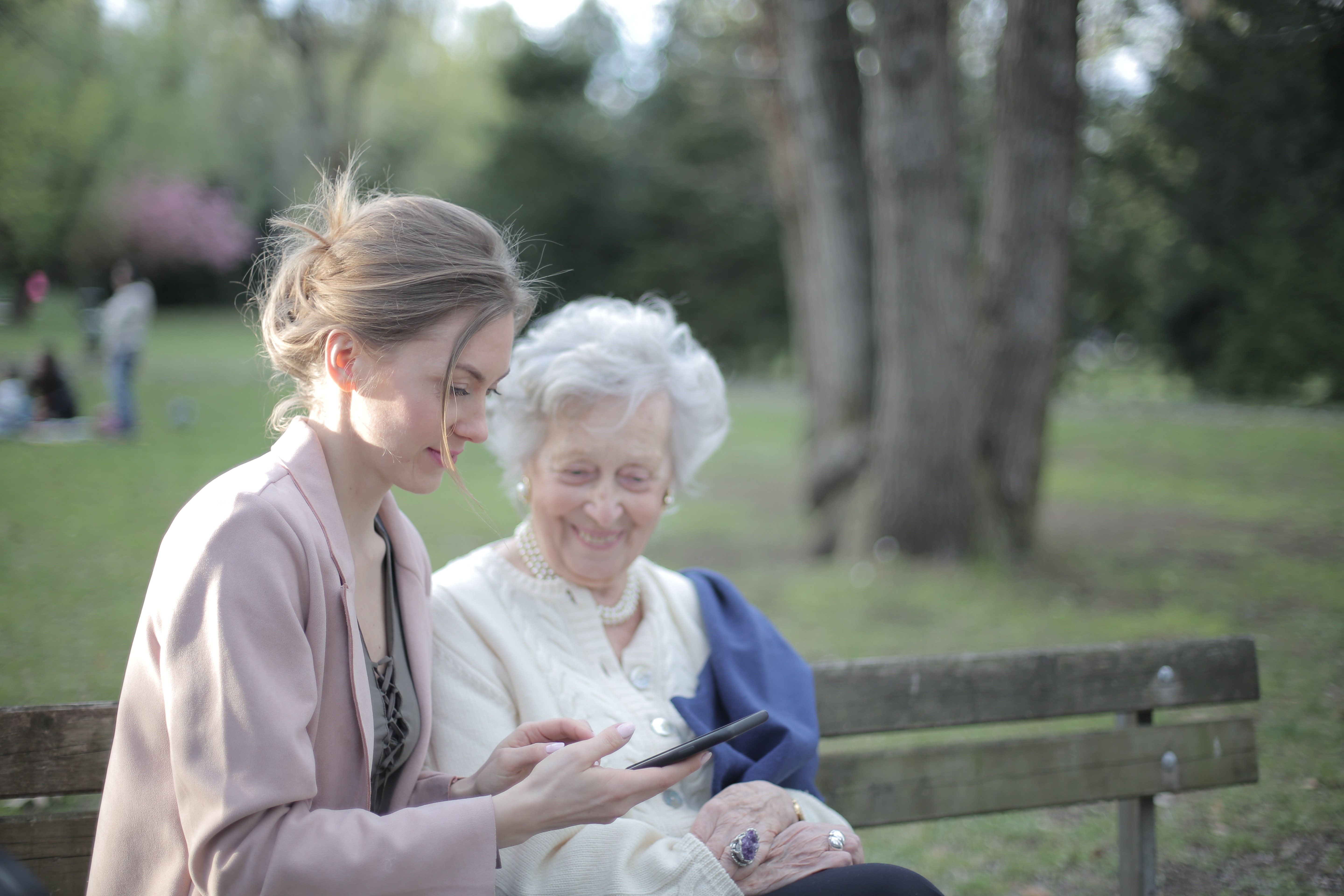 A family member sharing a quiet moment outdoors with an older woman