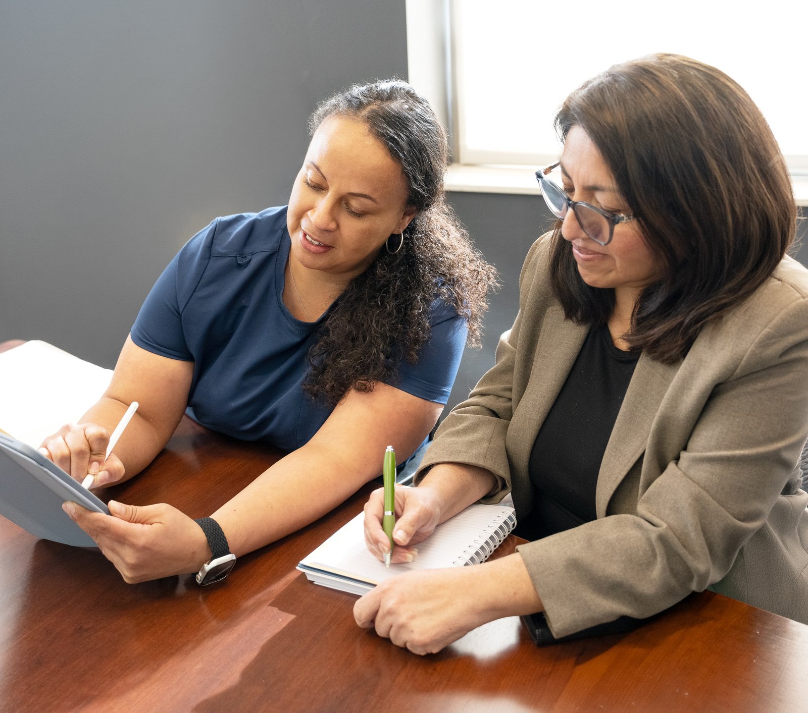 A Care Partner and a colleague reviewing a care plan together