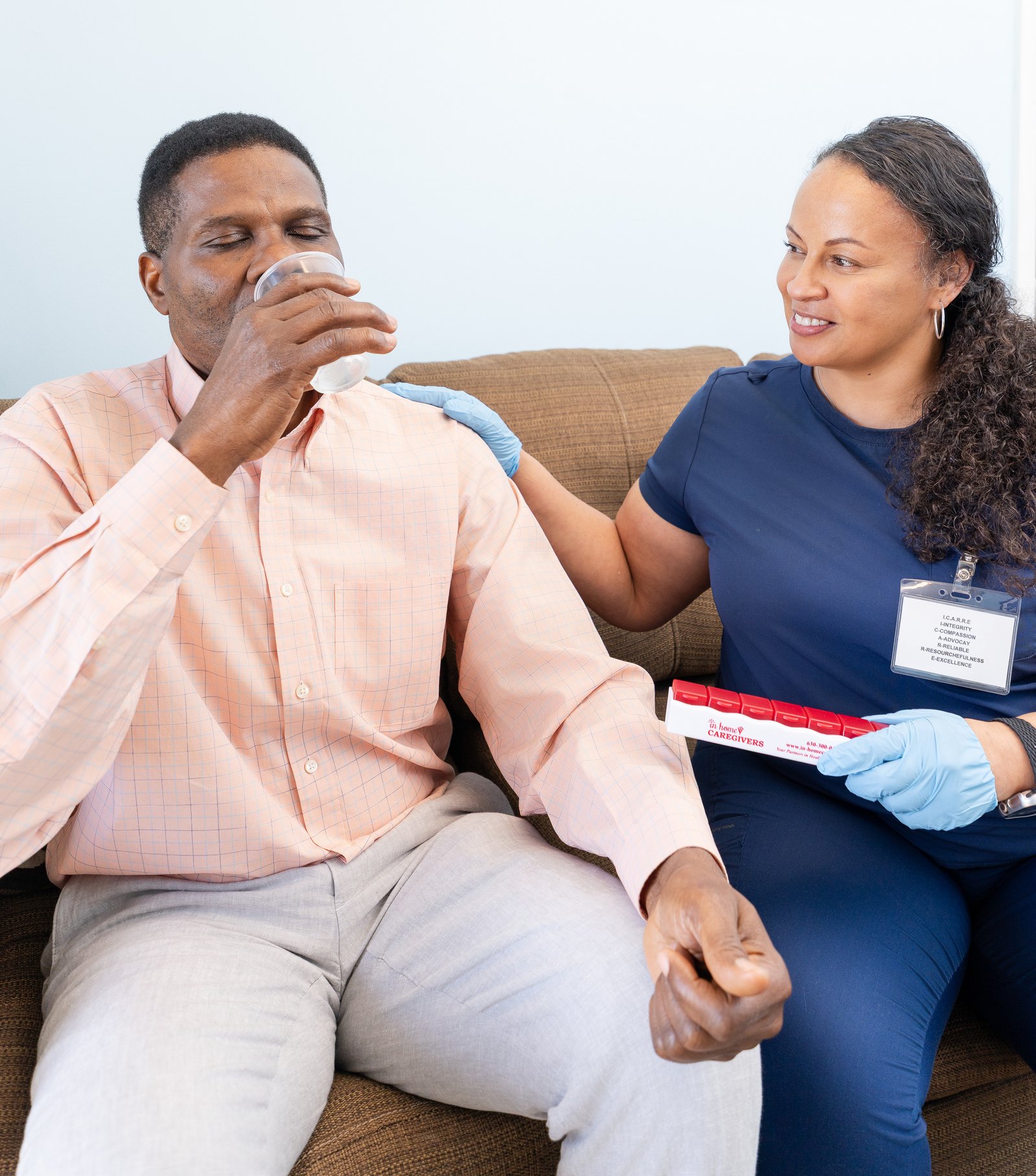 Medication support for a client sitting on the sofa