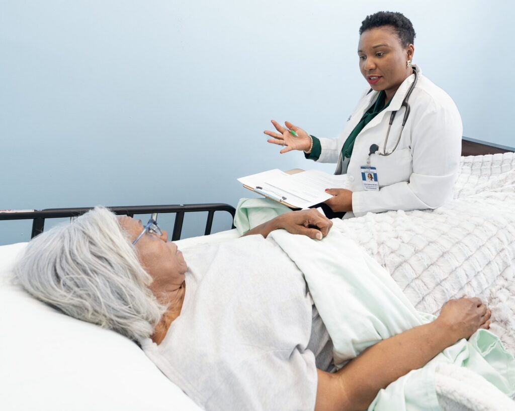 Isoken Ogbomo in conversation with a client during a wellness visit