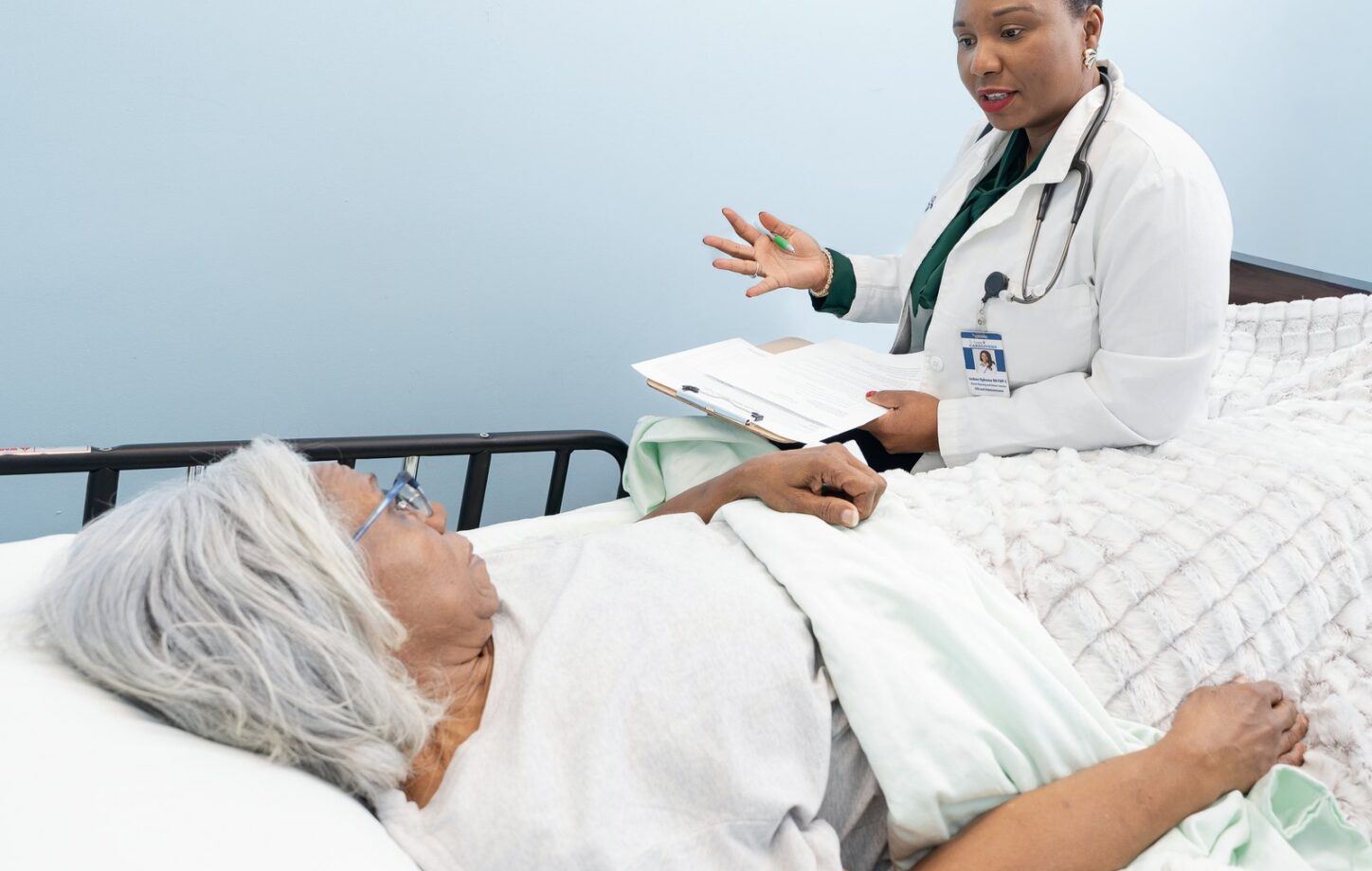 Isoken Ogbomo in conversation with a client during a wellness visit