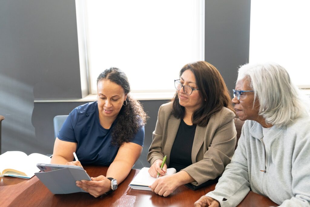 The care team reviewing a plan with a client and family member
