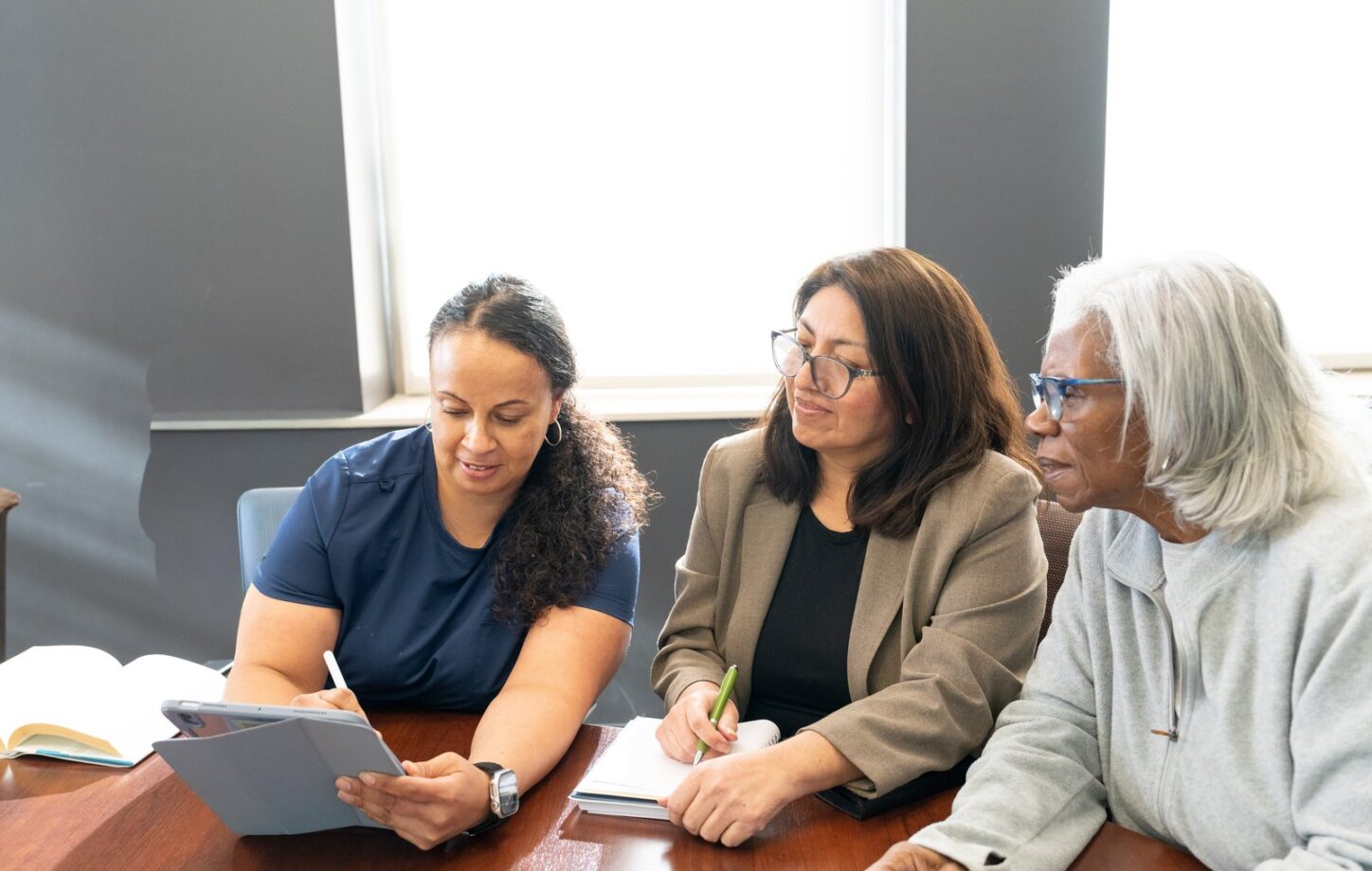 The care team reviewing a plan with a client and family member