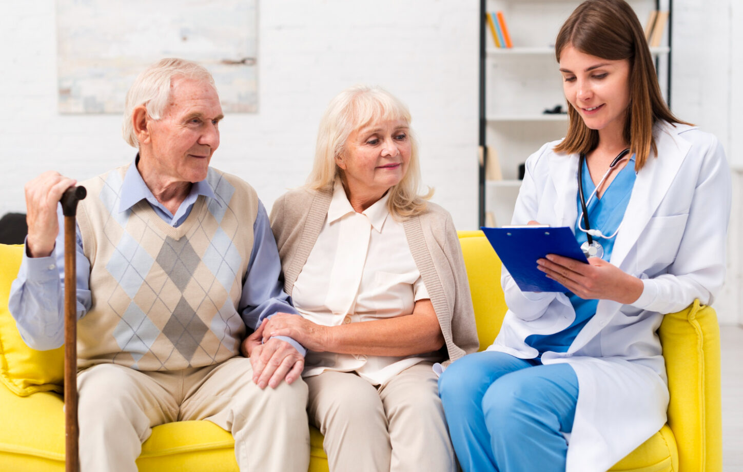 A nurse reviewing a care plan with an older couple at home